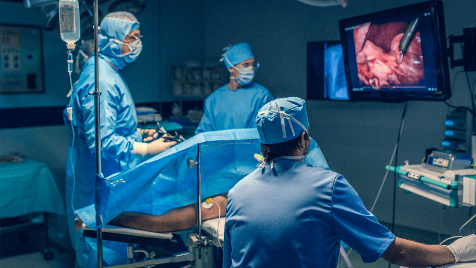 Doctors performing endoscopy with high-end equipment including video and camera